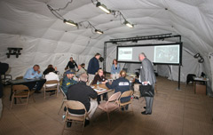 Personnel work inside a DRASH J Series Shelter. 