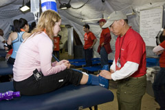 A runner is examined inside the DRASH medical surge facility. 