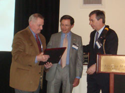 DHS Technologies CEO A. Jon Prusmack receives award plaquard for the company's anti-terrorism efforts during a recent event in NYC.