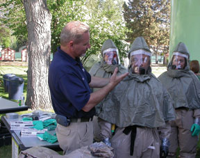 Ret. Army Medic Ken Hall trains hospital personnel during a decon demonstration in Boise, Idaho.